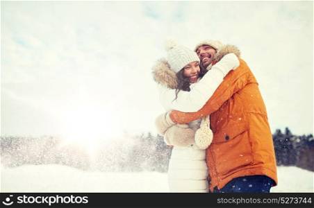 people, season, love and leisure concept - happy couple hugging outdoors in winter. happy couple hugging and laughing in winter
