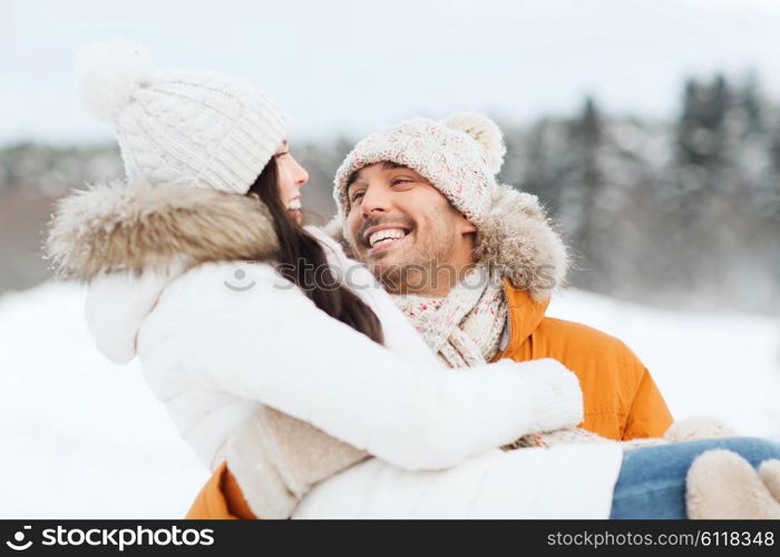 people, season, love and leisure concept - happy couple outdoors in winter