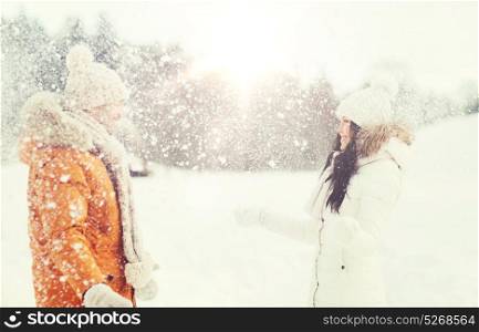people, season, love and leisure concept - happy couple playing with snow in winter. happy couple playing with snow in winter