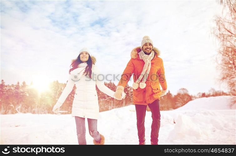 people, season, love and leisure concept - happy couple running in winter snow