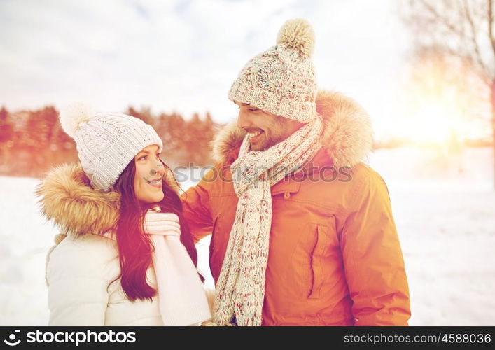 people, season, love and leisure concept - happy couple walking over winter background