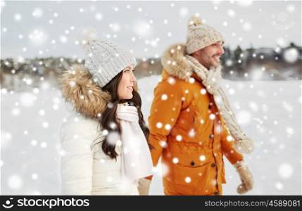 people, season, love and leisure concept - happy couple walking over winter background. happy couple walking over winter background