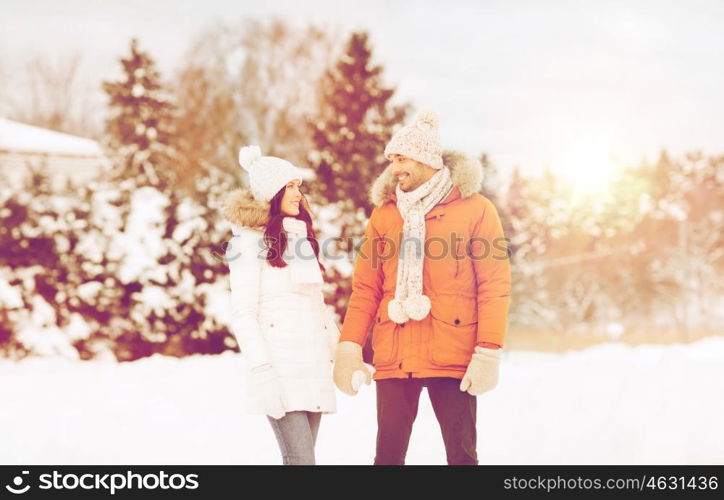 people, season, love and leisure concept - happy couple walking over winter background