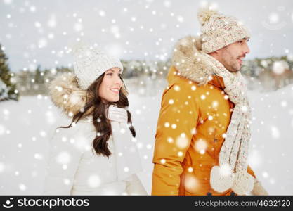 people, season, love and leisure concept - happy couple walking over winter background