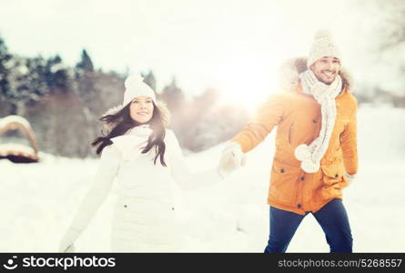 people, season, love and leisure concept - happy couple walking over winter background. happy couple walking over winter background