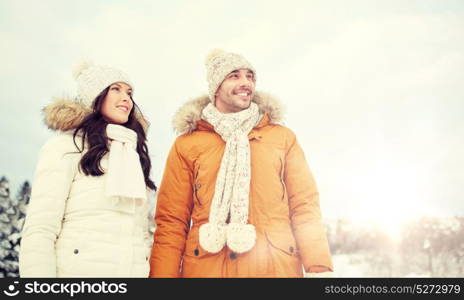 people, season, love and leisure concept - happy couple walking over winter background. happy couple walking over winter background