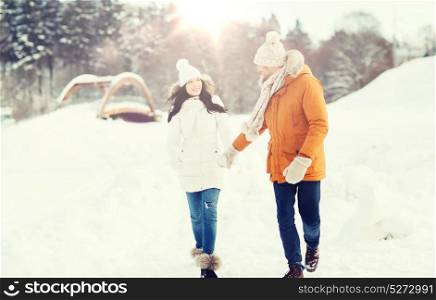 people, season, love and leisure concept - happy couple walking over winter background. happy couple walking over winter background