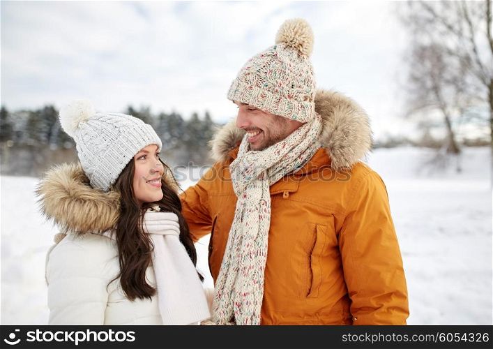 people, season, love and leisure concept - happy couple walking over winter background