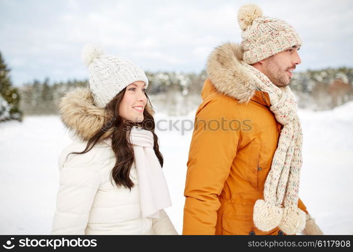 people, season, love and leisure concept - happy couple walking over winter background