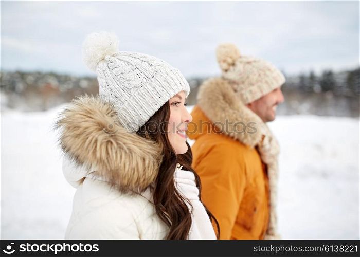 people, season, love and leisure concept - happy couple walking over winter background
