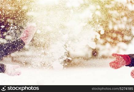 people, season, winter holidays and christmas concept - happy friends playing with snow outdoors. happy friends playing with snow in winter