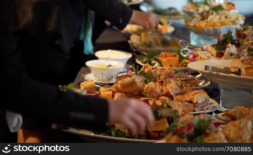 People selecting buffet food at an event