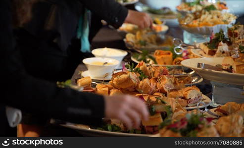 People selecting buffet food at an event