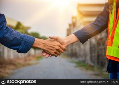 People Shake hand teamwork project success,Engineer hand shake outdoor background