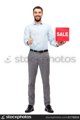 people, shopping, discount and holidays concept - smiling man holding red sale sign and showing thumbs up gesture