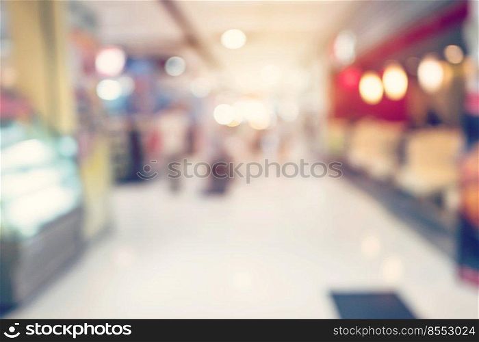 People shopping in department store. Defocused blur background.

