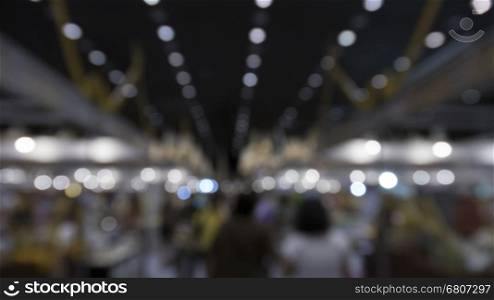 people shopping in exhibition trade fair - blur for use as background