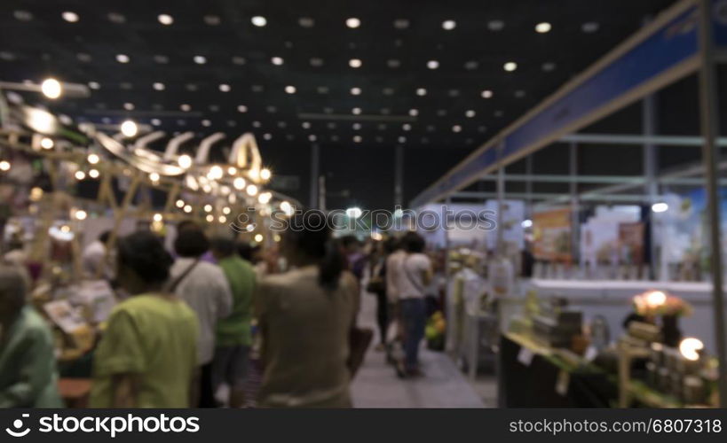 people shopping in exhibition trade fair - blur for use as background