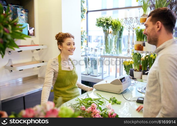 people, shopping, sale, floristry and consumerism concept - happy smiling florist woman and man or customer talking at flower shop