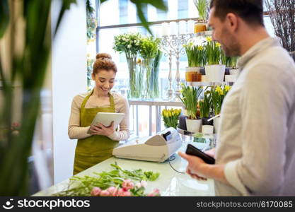 people, shopping, sale, floristry and consumerism concept - happy smiling florist woman with tablet pc computer and man with wallet at flower shop