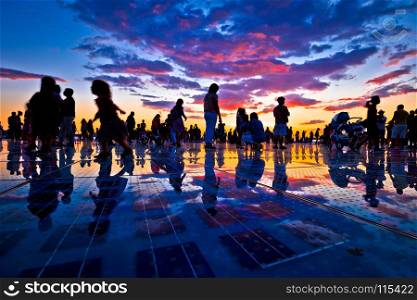 People silhouette on colorful sunset in Zadar, Dalmatia, Croatia