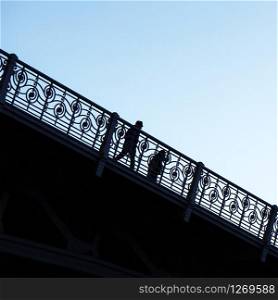 people silhouette on the bridge in Bilbao city Spain