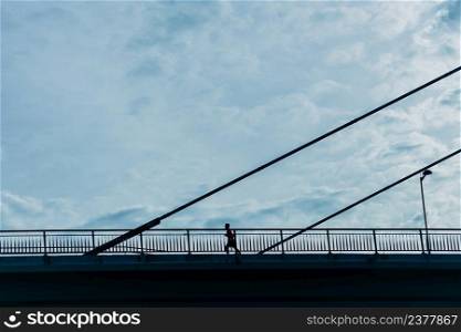 people silhouette on the bridge in Bilbao city, Spain