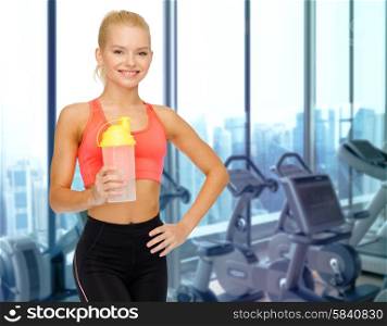 people, sport, fitness and recreation concept - happy woman with protein shake bottle over gym machines background