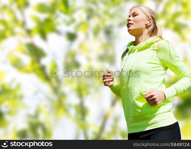 people, sport, fitness and slimming concept - happy woman running or jogging over green leaves background