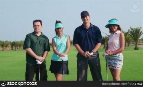 People, sport, leisure activity, recreation and lifestyle, golf in country club during summer holidays. Portrait of players in golf course, looking at camera. Friends, women and men. 7of30