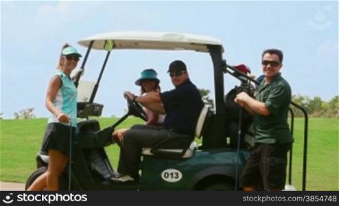 People, sport, leisure activity, recreation and lifestyle, group of friends talking and having fun on golf cart in club during summer holidays. Portrait of men and women looking at camera, 30of30
