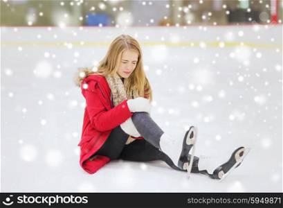 people, sport, trauma, pain and leisure concept - young woman fell down on skating rink and holding to her knee