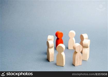People stand in a circle on a gray background. Communication. Business team, teamwork, team spirit. Wooden figures of people. A circle of people. discussion, cooperation, cooperation. Selective focus