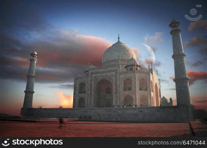 people stand in the archway and removed on the phone at the dawn of The Taj Mahal. Taj Mahal