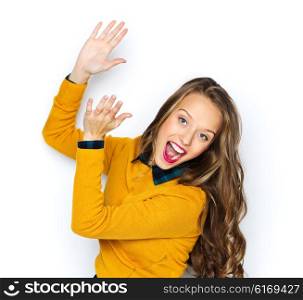 people, style and fashion concept - happy young woman or teen girl in casual clothes having fun and applauding