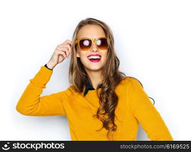 people, style and fashion concept - happy young woman or teen girl in casual clothes and sunglasses