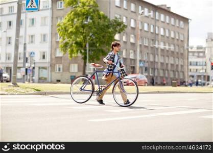 people, style, city life and lifestyle - young hipster man with shoulder bag and fixed gear bike crossing crosswalk on street