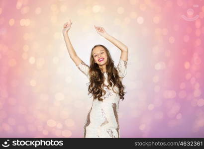 people, style, holidays and fashion concept - happy young woman or teen girl in fancy dress with sequins and long wavy hair dancing at party over rose quartz and serenity lights background