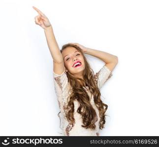 people, style, holidays and fashion concept - happy young woman or teen girl in fancy dress with sequins and long wavy hair dancing at party