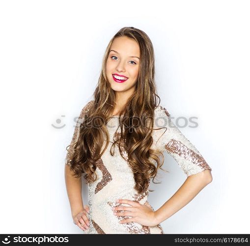 people, style, holidays, hairstyle and fashion concept - happy young woman or teen girl in fancy dress with sequins and long wavy hair
