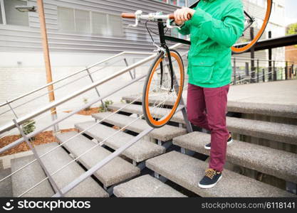 people, style, leisure and lifestyle - close up of man with fixed gear bike going downstairs