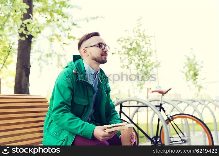 people, style, leisure and lifestyle - happy young hipster man with fixed gear bike on city street