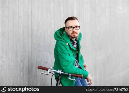 people, style, leisure and lifestyle - happy young hipster man with fixed gear bike on city street. happy young hipster man with fixed gear bike