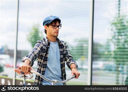 people, style, leisure and lifestyle - hipster man walking with fixed gear bike