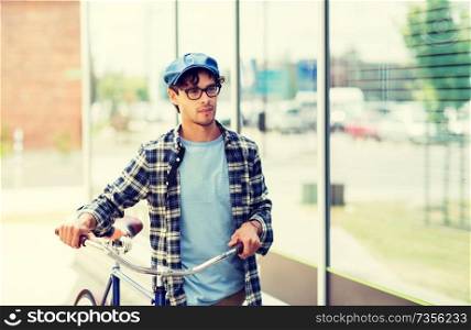 people, style, leisure and lifestyle - hipster man walking with fixed gear bike. hipster man walking with fixed gear bike