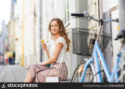 people, style, technology, leisure and lifestyle - happy young hipster woman with fixed gear bike eating ice cream on city street