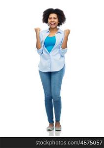 people, success and portrait concept - happy african american young woman with raised fists celebrating victory over white