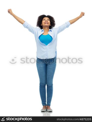 people, success and portrait concept - happy african american young woman with raised fists looking up over white