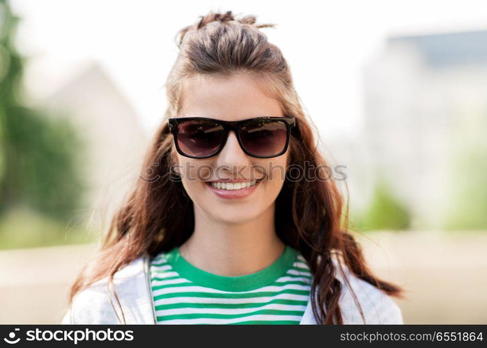 people, summer and eyewear - happy smiling young woman in sunglasses outdoors. happy young woman in sunglasses outdoors. happy young woman in sunglasses outdoors