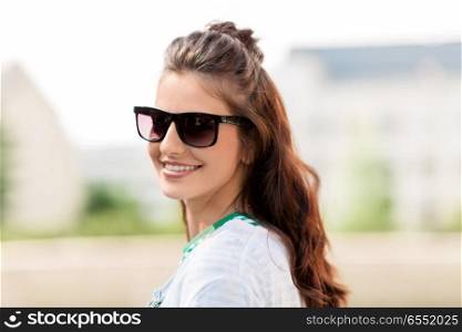people, summer and eyewear - happy smiling young woman in sunglasses outdoors. happy young woman in sunglasses outdoors. happy young woman in sunglasses outdoors